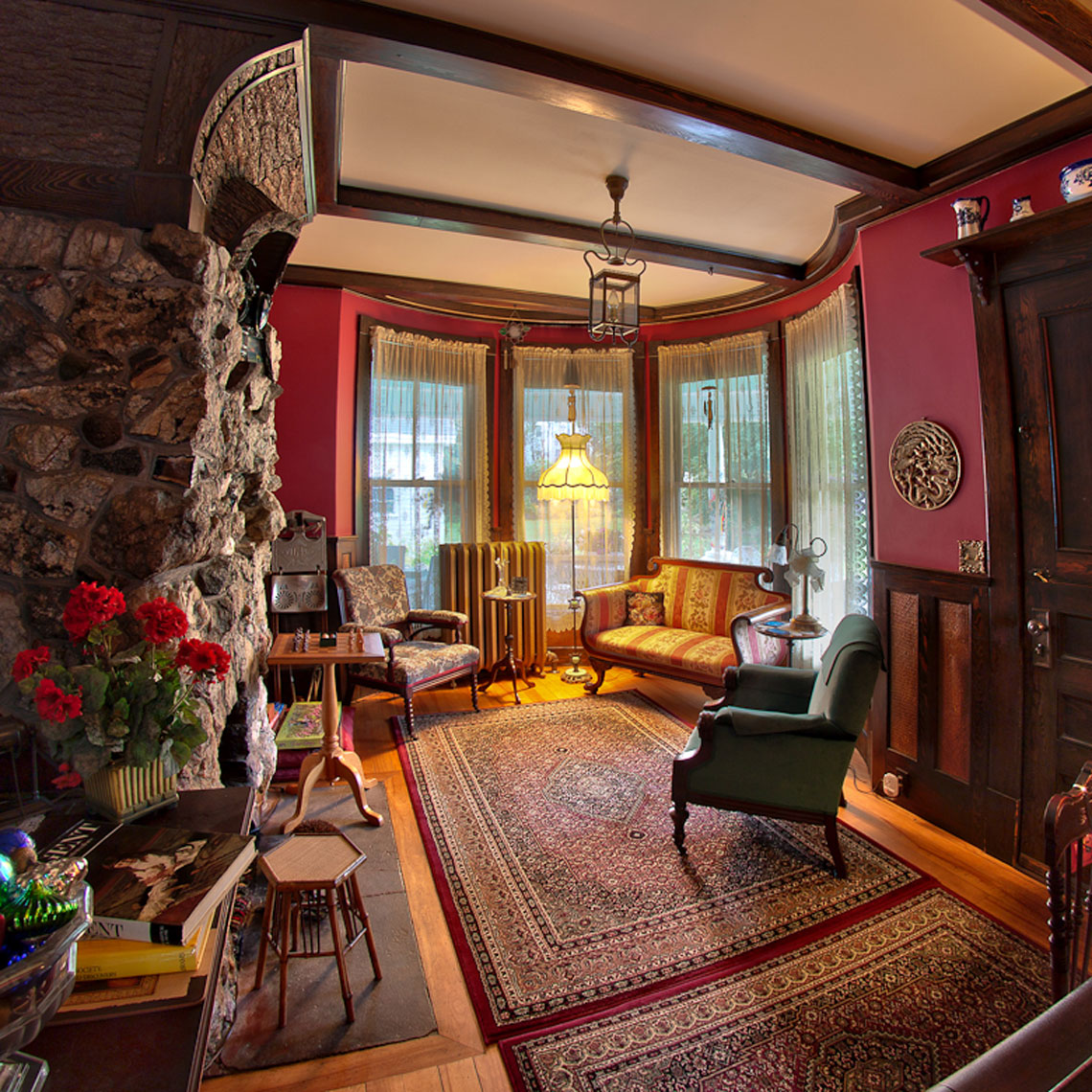 the jeweled turret inn den with stone fireplace